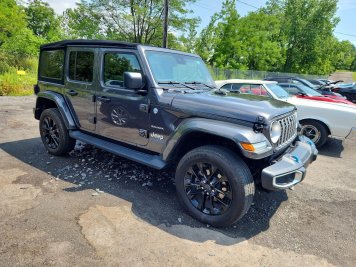 2024 jeep wrangler SAHARA 4XE in Black - Front Three-Quarter View - BidGoDrive Inventory